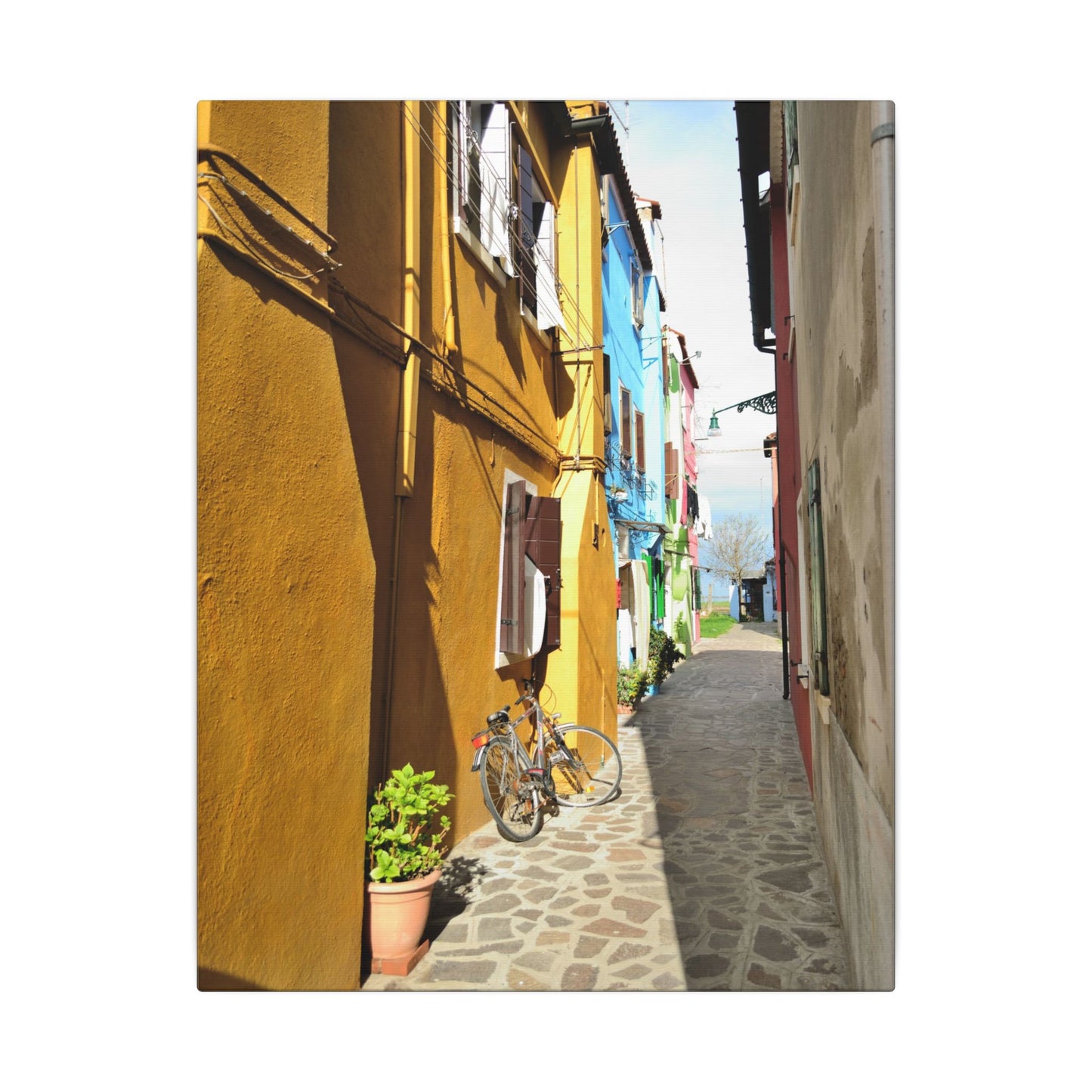 Mulano Street Scene Matte Canvas Print — Yellow Houses & Hanging Clothes, Stretched Wall Art